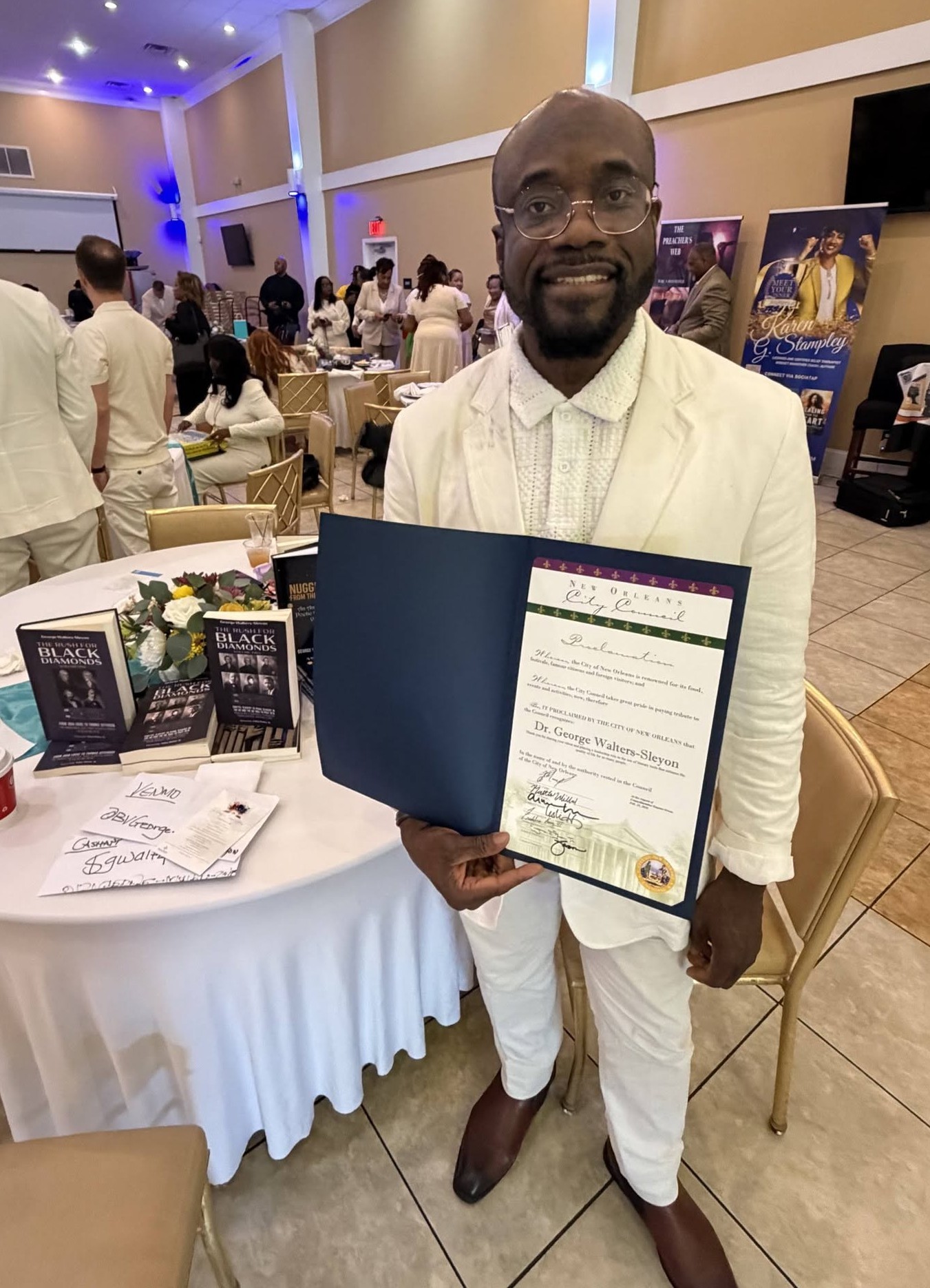 Dr. George Walters-Sleyon holding the official Proclamation from the City Council of the City of New Orleans